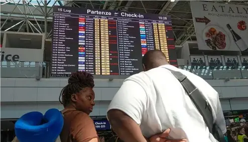  ?? ?? Passengers look at check-in times for   ights during a nationwide strike of airports ground sta  , and check-in services at Rome's Fiumicino Airport.