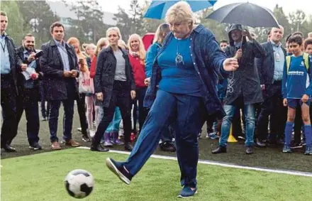  ?? EPA PIC ?? Norwegian Prime Minister Erna Solberg kicking a football at an election campaign event in Oslo on Saturday.