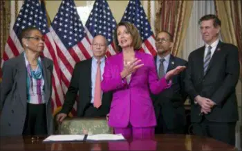  ?? J. SCOTT APPLEWHITE - THE ASSOCIATED PRESS ?? Speaker of the House Nancy Pelosi, D-Calif., talks to reporters after signing a Housepasse­d bill requiring that all government workers receive retroactiv­e pay after the partial shutdown ends, at the Capitol in Washington, Friday. She is joined by, from left, Delegate Eleanor Holmes Norton, D-D.C., Rep. Peter DeFazio, D-Ore., Rep. Anthony Brown, D-Md., and Rep. Don Beyer D-Va.