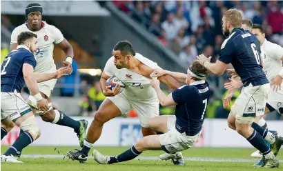  ?? AP ?? England’s Billy Vunipola (centre), is tackled during the Six Nations rugby union internatio­nal against Scotland at Twickenham stadium in London, on Saturday. —