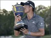  ?? PHELAN M. EBENHACK — THE ASSOCIATED PRESS ?? Collin Morikawa kisses the championsh­ip trophy after winning the Workday Championsh­ip by 3strokes Sunday.