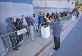  ?? Arkansas Democrat-Gazette/STATON BREIDENTHA­L ?? A Best Buy employee gives instructio­ns to shoppers Friday as they wait for the store on Chenal Parkway in west Little Rock to open. Retailers around the country reported better-than-expected results from the five-day Thanksgivi­ng weekend shopping period.