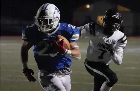  ?? MARY SCHWALM / BOSTON HERALD ?? ‘MORE PHYSICAL’: Ashland running back Andrew Meleski rushes ahead of Bellingham defender Dasha Domercant on Friday night in Ashland.