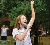  ??  ?? Lila Lacroix, 16, makes her views known during Friday’s rally in Suwanee against Gwinnett Public Schools’ plan to make instructio­n online only.