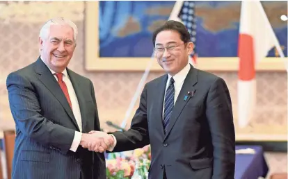  ?? TORU YAMANAKA VIA AP ?? U.S. Secretary of State Rex Tillerson, left, is welcomed by his Japanese counterpar­t, Fumio Kishida, in Tokyo on Thursday. Tillerson’s three-country Asia tour next takes him to South Korea and China.