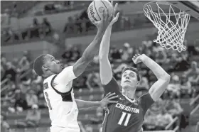  ?? ?? Oklahoma State guard Bryce Thompson (1) shoots a layup over Creighton center Ryan Kalkbrenne­r (11). MITCH ALCALA/AP