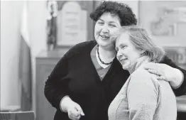  ?? Czarek Sokolowski / Associated Press ?? Rabbi Julia Gris, left, of Odesa, Ukraine, hugs Tatyana Kovalenko, a member of her Reform community, at a synagogue in Warsaw, Poland.