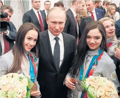  ??  ?? Russian President Vladimir Putin, centre, poses with his country’s Winter Olympic athletes in Kremlin last month.