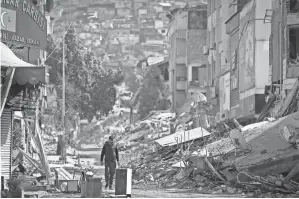  ?? UNAL CAM/AP ?? Rubble from destroyed buildings is seen Tuesday in Antakya, Turkey. Monday’s earthquake killed six in Turkey and two in Syria.