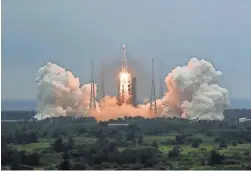  ?? JU ZHENHUA/AP ?? A Long March 5B rocket carrying a module for a Chinese space station lifts off April 29 in southern China’s Hainan Province.