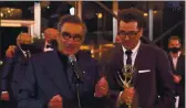  ?? AP IMAGES ?? Eugene Levy, left, and Daniel Levy from “Schitt’s Creek” accept the Emmy for Outstandin­g Comedy Series during the 72nd Emmy Awards telecast.