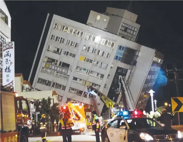  ?? Picture: AP ?? DANGER ZONE: Rescuers enter a building that collapsed on to its side in the 6.4-magnitude earthquake in Hualien County, eastern Taiwan.