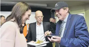 ?? PHOTOS: GERARD O’BRIEN ?? Meaty subject . . . Prime Minister Jacinda Ardern, Nigel Jones (centre), from Alliance, and Invercargi­ll Mayor Tim Shadbolt chat around hors d’oeuvres at Lorneville meat plant.