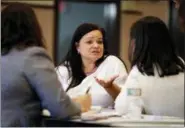  ?? JULIO CORTEZ — THE ASSOCIATED PRESS ?? On April 14, Nelly Masa, who was displaced from her home in Puerto Rico, talks to paralegals during an event to help those affected by Hurricane Maria in Elizabeth, New Jersey. How many have permanentl­y relocated because of Hurricane Maria is not yet...