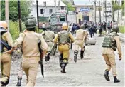  ??  ?? A group of policemen intervenes after students resorted to stone pelting during a clash outside Gandhi Memorial College at Babademb, Srinagar, on Wednesday