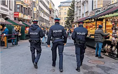  ?? ?? Passports, please: Austrian police in Vienna monitor compliance with stringent Covid measures earlier this week. Austria went on to announce a full lockdown yesterday