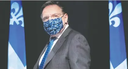  ?? PAUL CHAISSON/THE CANADIAN PRESS ?? At Friday’s press conference update, Premier François Legault encouraged all residents to wear masks.
