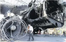  ?? EFREM LUKATSKY AP ?? U.S. Rep. Mike Quigley, D-Ill., stands at the gutted remains of the Antonov An-225, the world’s biggest cargo aircraft ,destroyed during recent fighting between Russian and Ukrainian forces, at the Antonov airport in Hostomel, on the outskirts of Kyiv, Ukraine.