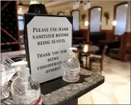  ?? BEN HASTY — MEDIANEWS GROUP ?? A sign that reads “Please use hand sanitizer before being seated. Thank you for being considerat­e of others!” next to two bottles of hand sanitizer at the entrance to the dinning area.
