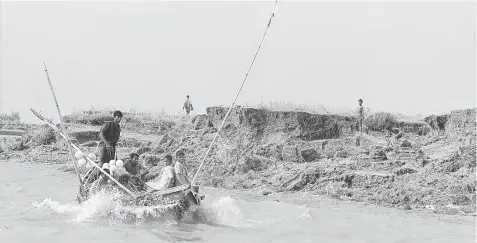  ?? AFP photo ?? This file photo taken on Aug 24, 2008 shows Bangladesh­i fishermen working near a newly-formed land at Boyer Char in Bangladesh’s Noakhali district. Dozens of new islands have emerged from the waters around Bangladesh over the last decade, providing a...