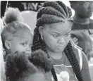  ?? BARBARA HADDOCK TAYLOR/BALTIMORE SUN ?? Shanika Robinson, mother of Taylor Hayes, listens during a moment of silence during a Peace Walk that was held in her honor last month. Taylor was fatally shot in 2018.