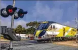  ?? LANNIS WATERS / THE PALM BEACH POST ?? Work to complete a railroad quiet zone is on hold while Brightline focuses on launching its Miami service.