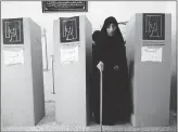  ??  ?? On Saturday, an Iraqi woman leaves a voting booth during the parliament­ary elections at a polling station in Baghdad.