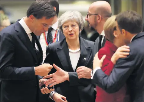  ??  ?? NEGOTIATIO­NS: Prime Minister Theresa May, centre, arriving for a round table meeting at the EU summit in Brussels last week.