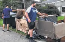  ?? Glynn A. Hill / Houston Chronicle ?? Joseph Dill helps clean up the house of four Rice football teammates that was flooded by Harvey.