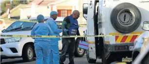  ?? Picture: MARK ANDREWS ?? LINE OF FIRE: Members of the SAPS at the scene in Usher Street, in Southernwo­od, where a SBV cash-in-transit van was dumped by robbers.