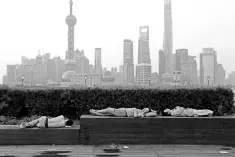  ??  ?? People sleeping on the waterfront bund to keep cool in Shanghai. US corporate acquisitio­ns in China collapsed to their lowest level for 14 years in the first half of this year, as trade tensions between the two countries and uncertaint­y about Chinese...