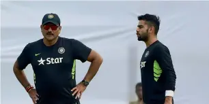  ?? AFP ?? India team director Ravi Shastri (left) and captain Virat Kohli (R) talk during a practice session in Narayangan­j on Tuesday ahead of the Test match against Bangladesh. —