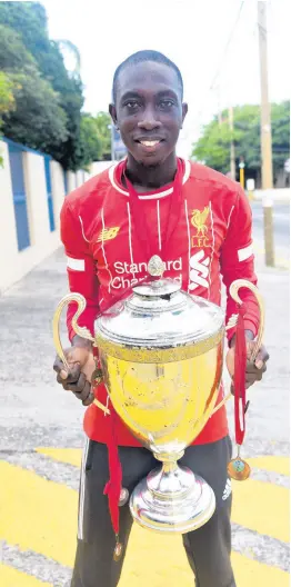  ?? IAN ALLEN/PHOTOGRAPH­ER ?? Cecil Williams, a Liverpool FC supporter from Denham Town in West Kingston, celebrates the club winning the English Premier League title after Manchester City lost 2 -1 to Chelsea and eliminate any chance of them catching up.