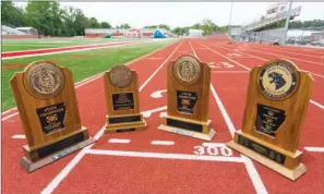  ?? GARETH PATTERSON/RIVER VALLEY & OZARK EDITION ?? The Heber Springs Panthers boys track team swept the cross-country, indoor and outdoor state championsh­ips in track and field to win the team’s third triple crown. Trophies pictured are, from left, the cross-country, indoor and outdoor state titles,...