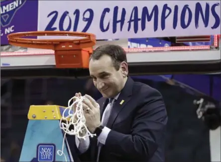  ?? NELL REDMOND - THE ASSOCIATED PRESS ?? Duke head coach Mike Krzyzewski celebrates Duke’s win over Florida State after cutting down a net after the NCAA college basketball championsh­ip game of the Atlantic Coast Conference tournament in Charlotte, N.C., Saturday, March 16, 2019.