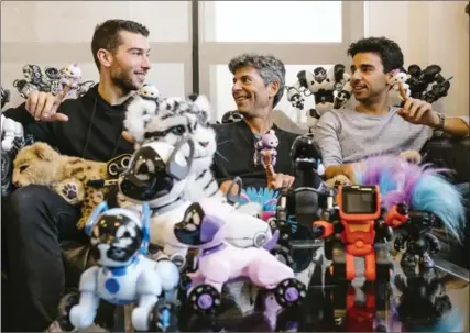  ?? RENAUD PHILIPPE, NEW YORK TIMES ?? Richard Yanofsky, centre, a founder of WowWee, poses for a photo with his sons, Michael, left, and Andrew amid an array of toys at the company’s offices.