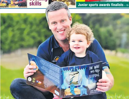  ?? PHOTO: CHRISTINE O’CONNOR ?? Story time . . . Dunedin firefighte­r Kris Kennett reads a copy of the book The Wolf Was Not Sleeping to his daughter, Sophie (1).