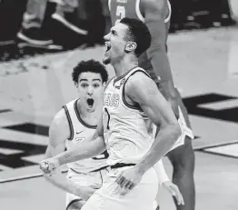  ?? Darron Cummings / Associated Press ?? Gonzaga guard Jalen Suggs celebrates making the game-winning basket against UCLA for a 93-90 overtime win in a national semifinal game Saturday.