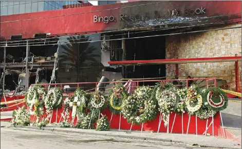  ?? (File Photo/AP/Hans-Maximo Musielik) ?? A makeshift memorial of funeral wreaths line the circular driveway of the Casino Royale on Aug. 27, 2011.