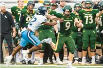  ?? MIKE CAUDILL/FREELANCE ?? William & Mary running back Bronson Yoder stiff-arms Maine defensive back Abdul Stewart in the first half in Williamsbu­rg.