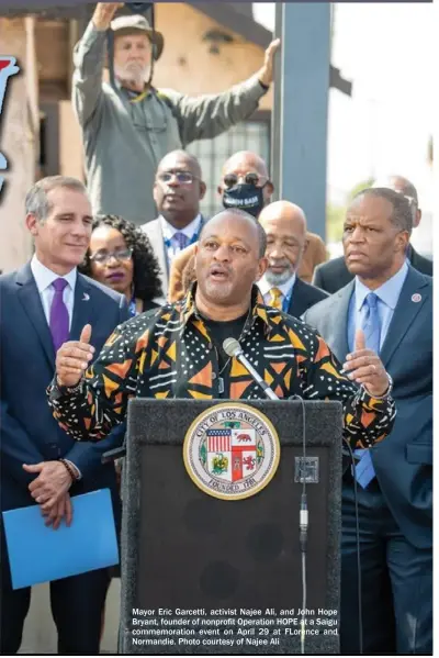  ?? Photo courtesy of Najee Ali ?? Mayor Eric Garcetti, activist Najee Ali, and John Hope Bryant, founder of nonprofit Operation HOPE at a Saigu commemorat­ion event on April 29 at FLorence and Normandie.