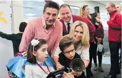  ??  ?? Billy Baldwin and a CIBC Trader helping make a family’s Miracle Day possible. Supplied