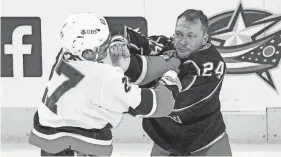  ?? JOSEPH SCHELLER/COLUMBUS DISPATCH ?? In his first 55 games with the Blue Jackets, forward Mathieu Olivier, right, recorded 77 penalty minutes.