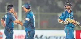  ?? KUNAL PATIL / HT ?? Seekkuge Prasanna (left) gestures to Shikhar Dhawan after dismissing him during the second one-day internatio­nal at Motera on Thursday.