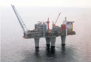 ?? MARIT HOMMEDAL SCANPIX VIA THE ASSOCIATED PRESS FILE PHOTO ?? A gas platform run by the Norwegian oil giant Statoil stands above the North Sea. Norway’s $1.3-trillion wealth fund plans to take a critical look at the stakes it holds in national oil firms.