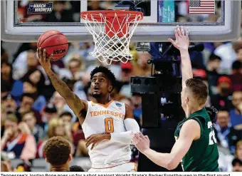  ??  ?? Tennessee’s Jordan Bone goes up for a shot against Wright State’s Parker Ernsthause­n in the first round of the NCAA Tournament at American Airlines Center in Dallas on Thursday.