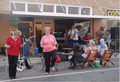  ?? Staff photos by Neil Abeles ?? n ABOVE LEFT: The music of Music on Main Street is so good that Janet Points and Jana Bounds get up to dance. The band musicians in the background are Johnny Points, Donnie Lowry, Randy Turner, John Bankhead, Scott Venable, Glenn McGill and Bill Cox.