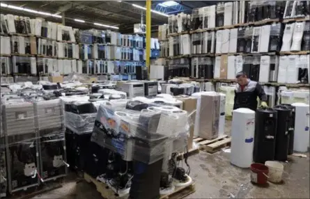  ?? SETH WENIG — THE ASSOCIATED PRESS ?? Water coolers wait to be recycled at a GDB Internatio­nal warehouse in Monmouth Junction, N.J. Investment­s have increased in plants that process recyclable­s no longer being shipped overseas.