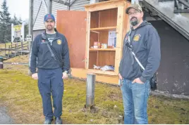  ?? ?? Volunteer firefighte­rs with the Albert Bridge department Dan MacMillan, left, and Tyler Naugler stand next to the nearly empty food cupboard outside their station. Misuse of the outdoor cupboard, meant to help people dealing with food insecurity, has led to the department’s decision to close it. NICOLE SULLIVAN • CAPE BRETON POST