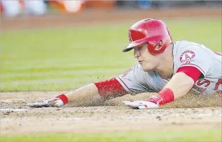  ?? Tony Avelar Associated Press ?? GOING IN HEADFIRST, as he did while scoring in a 2014 game at Oakland, had never been a problem for the Angels’ Mike Trout — until nine days ago, when the two-time MVP tore a ligament in his left thumb on a headfirst slide into second base against Miami.